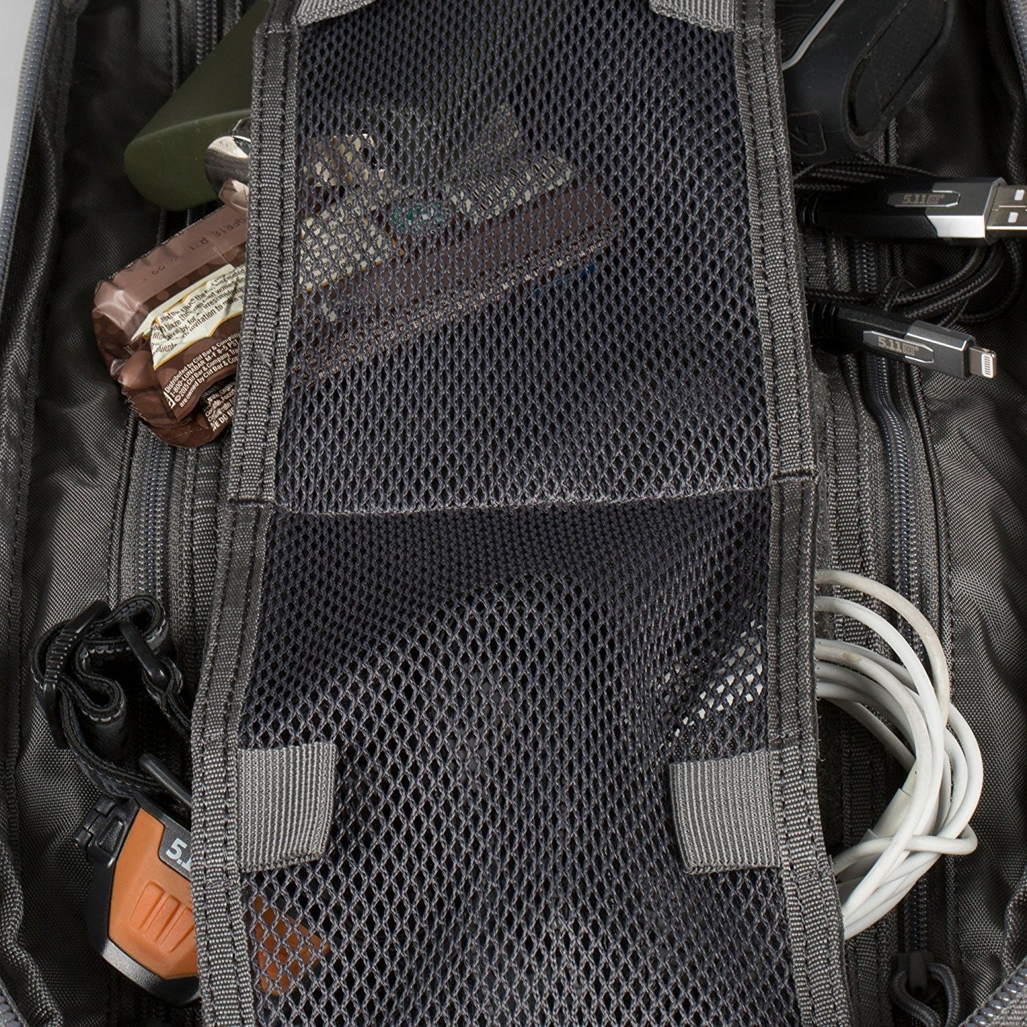 an open suitcase filled with electronics and cords