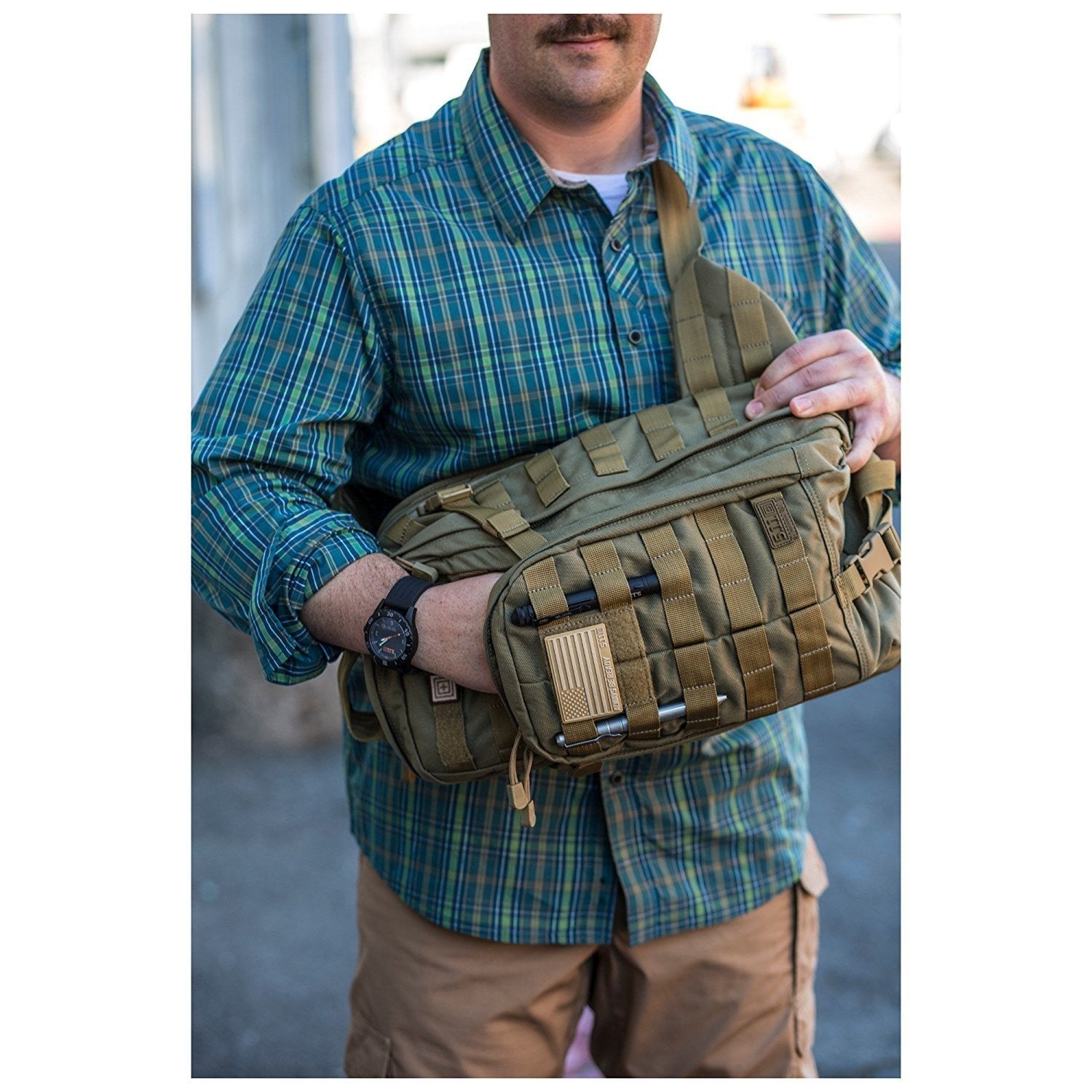 a man in a plaid shirt is holding a bag